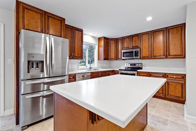 kitchen featuring sink, light tile patterned flooring, a breakfast bar, a kitchen island, and appliances with stainless steel finishes