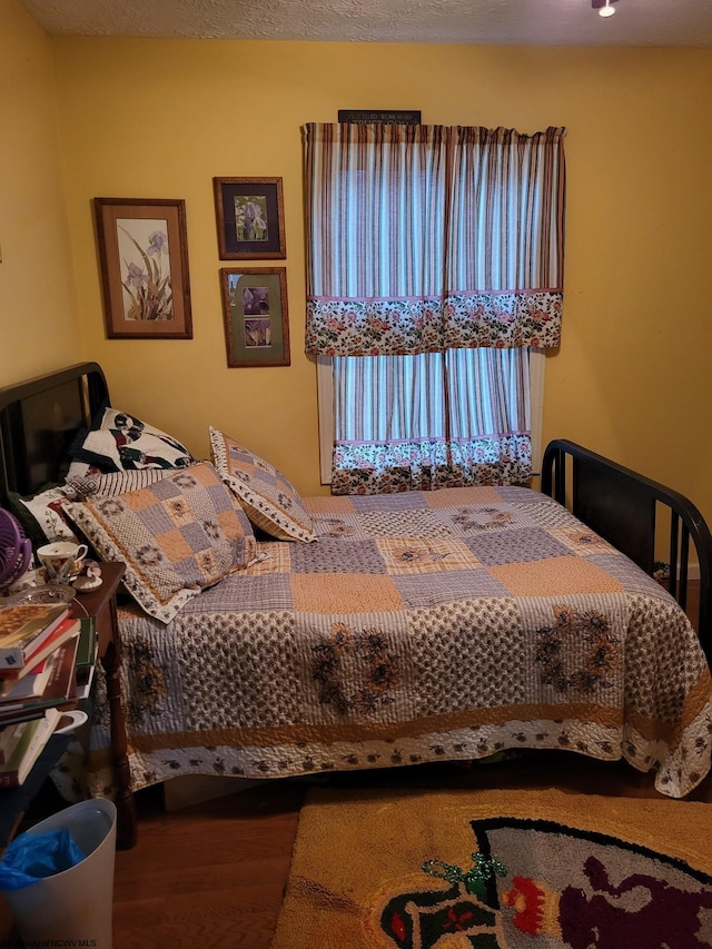 bedroom with hardwood / wood-style flooring