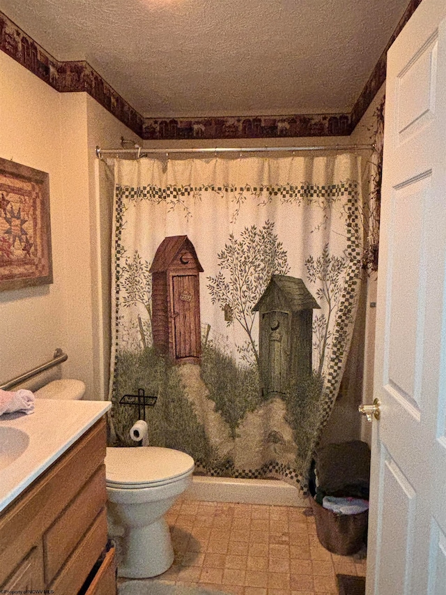 bathroom featuring vanity, toilet, a textured ceiling, and walk in shower