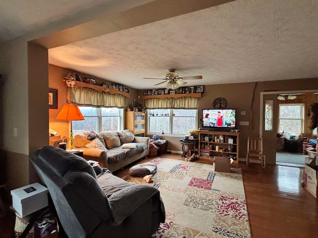 living room featuring a textured ceiling, hardwood / wood-style flooring, and ceiling fan