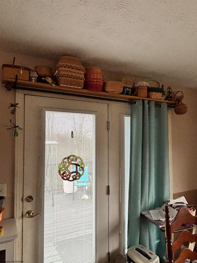 doorway with a textured ceiling