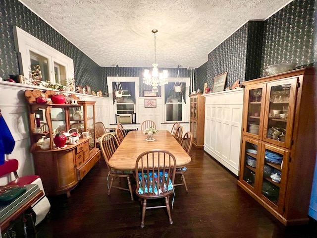 dining room featuring a textured ceiling, dark hardwood / wood-style floors, and a notable chandelier