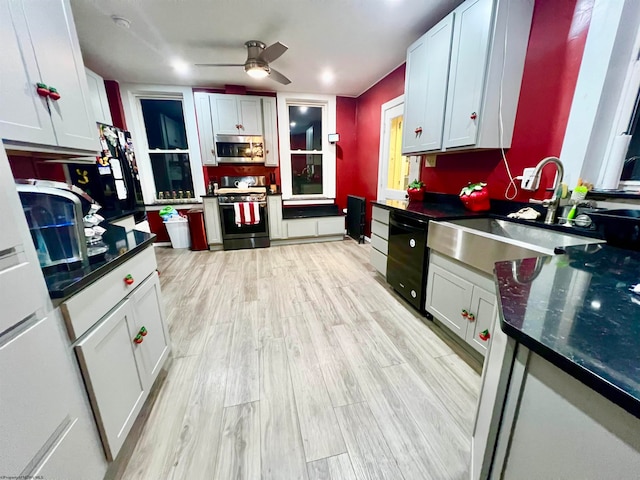 kitchen with light hardwood / wood-style floors, white cabinetry, sink, and appliances with stainless steel finishes