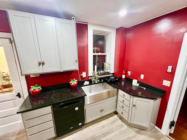 kitchen featuring white cabinets, light hardwood / wood-style floors, and dishwasher