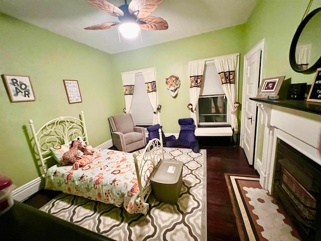 bedroom featuring ceiling fan and dark hardwood / wood-style flooring