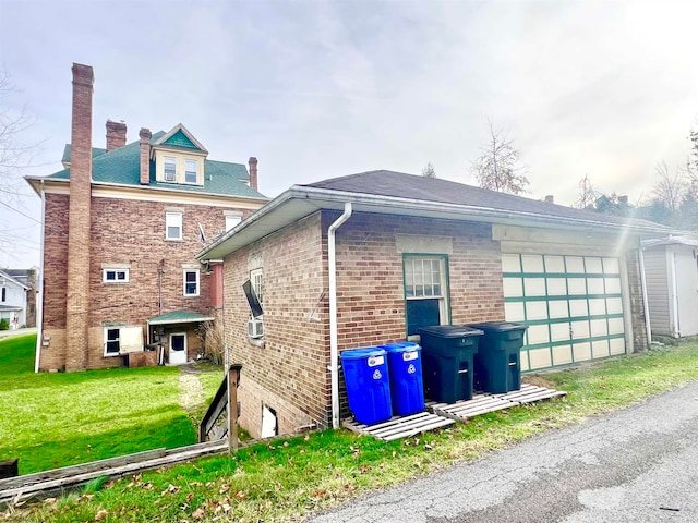 view of side of home with a lawn and a garage