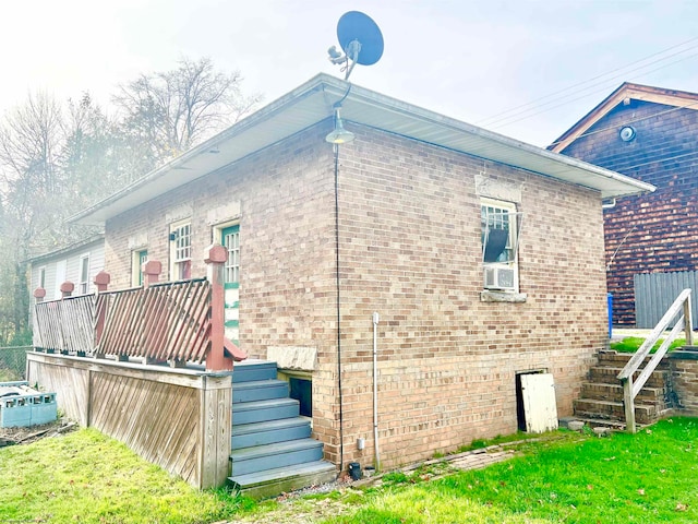 rear view of property featuring cooling unit and a yard