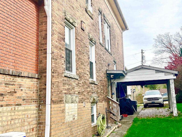 view of side of property featuring cooling unit and a carport