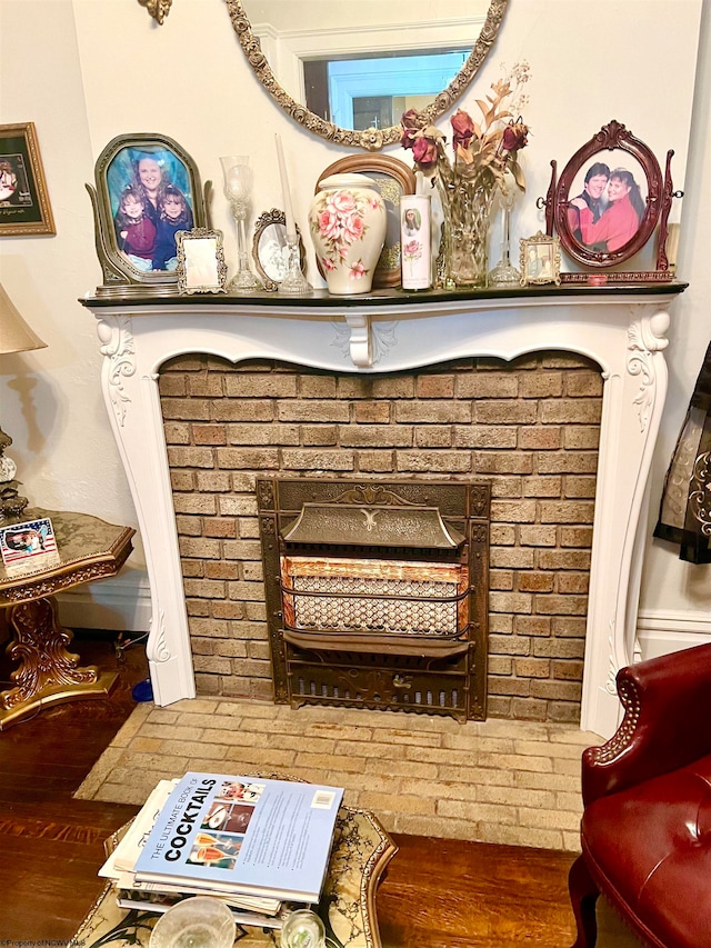 details featuring wood-type flooring and a brick fireplace