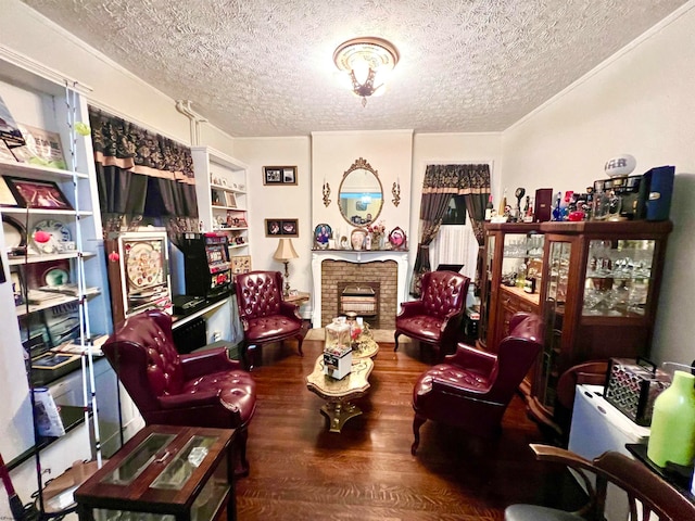 sitting room featuring a fireplace, a textured ceiling, and hardwood / wood-style flooring