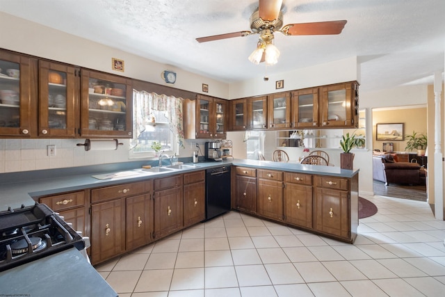 kitchen featuring dishwasher, sink, kitchen peninsula, a textured ceiling, and light tile patterned floors