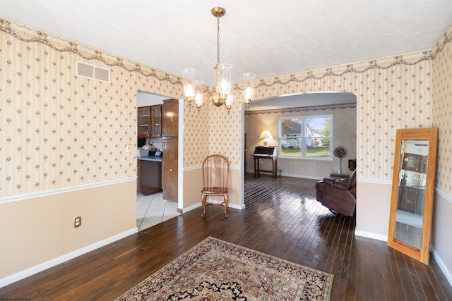 dining area featuring a notable chandelier and hardwood / wood-style flooring