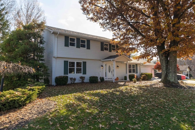 front of property with a front lawn and a garage