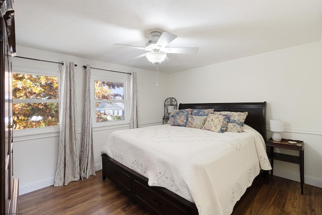 bedroom with ceiling fan and dark hardwood / wood-style flooring