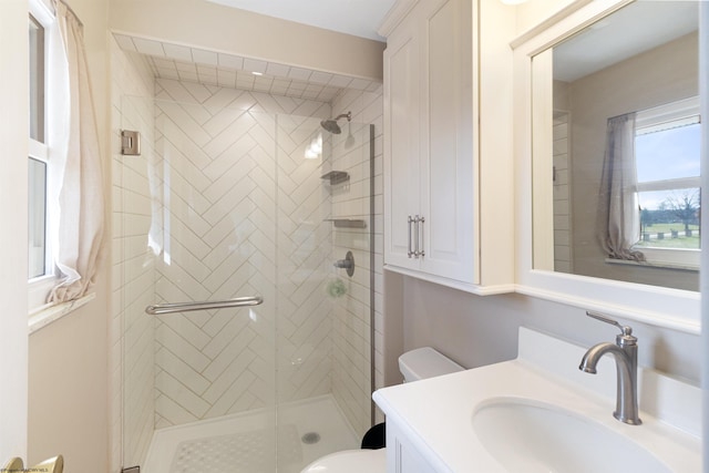 bathroom featuring walk in shower, vanity, and toilet