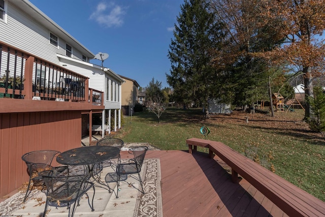 wooden deck featuring a lawn