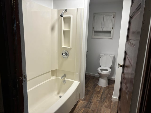 bathroom with hardwood / wood-style floors, shower / bath combination, and toilet