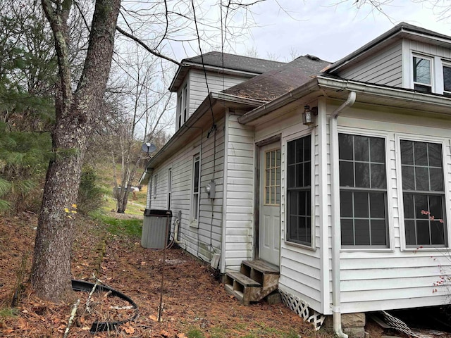 view of side of property with central air condition unit