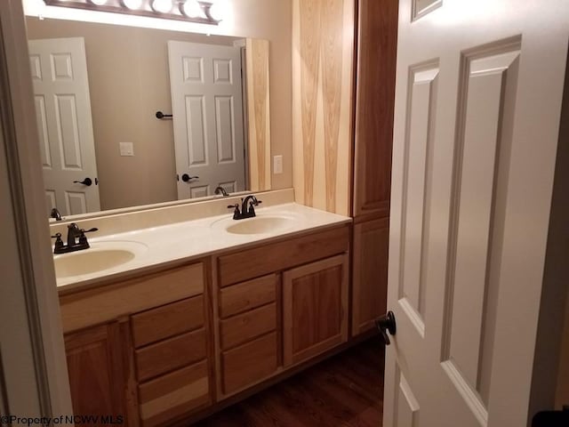 bathroom with hardwood / wood-style flooring and vanity