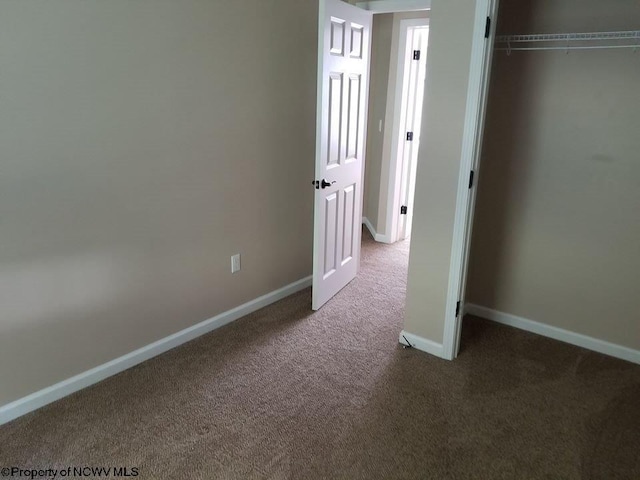 unfurnished bedroom featuring a closet and carpet