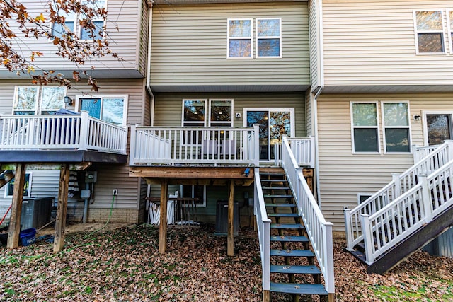 rear view of property with central AC unit and a deck