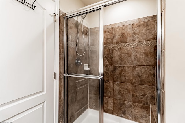 bathroom with a shower with door