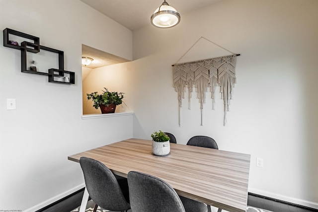 dining area featuring hardwood / wood-style flooring and a baseboard heating unit