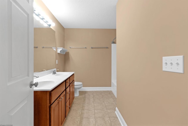 bathroom with tile patterned floors, vanity, a textured ceiling, and toilet