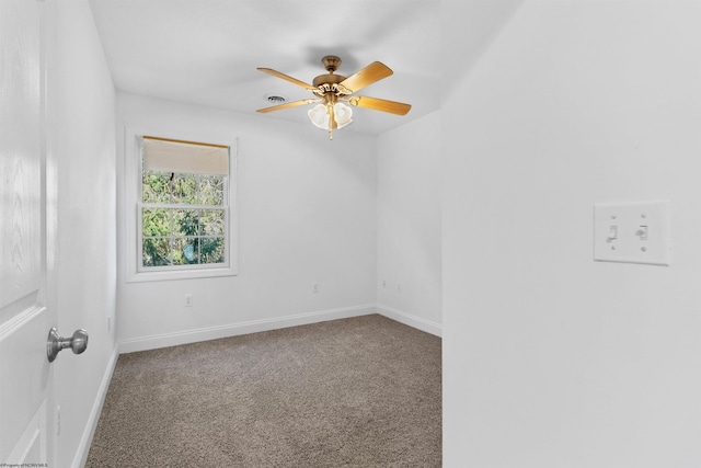 carpeted spare room with ceiling fan