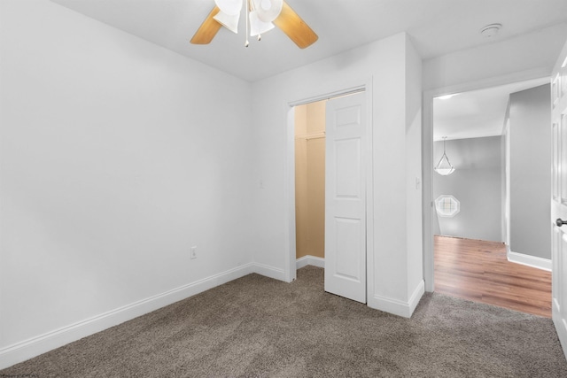 unfurnished bedroom featuring ceiling fan, a closet, and carpet floors