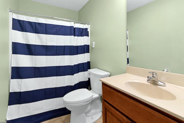 bathroom featuring toilet, vanity, tile patterned floors, and walk in shower