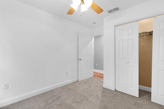 unfurnished bedroom with ceiling fan, a closet, and carpet floors