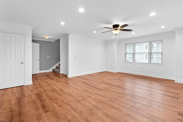 empty room featuring ceiling fan, light wood-type flooring, and ornamental molding