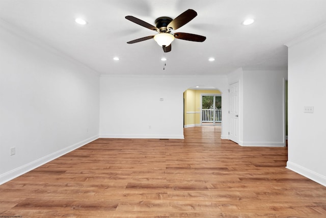 spare room with ceiling fan, ornamental molding, and light hardwood / wood-style flooring