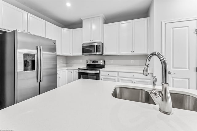 kitchen with white cabinets, sink, and stainless steel appliances