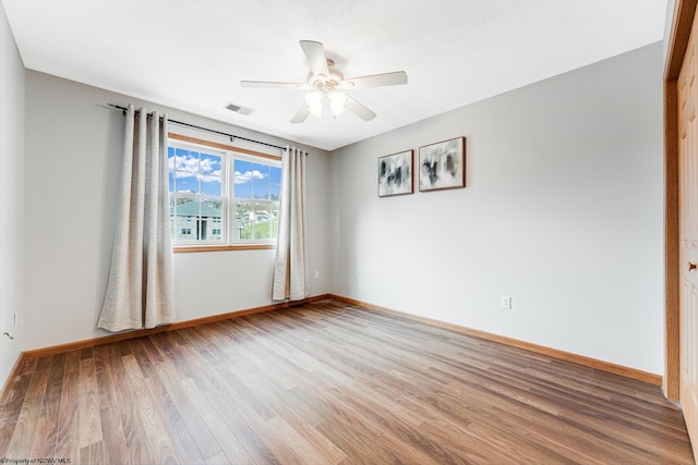 spare room featuring hardwood / wood-style floors and ceiling fan