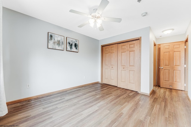 unfurnished bedroom featuring light wood-type flooring, a closet, and ceiling fan