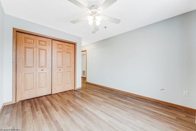 unfurnished bedroom featuring ceiling fan, a closet, and light hardwood / wood-style floors