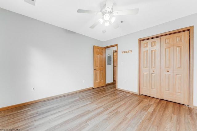 unfurnished bedroom with ceiling fan, a closet, and light wood-type flooring