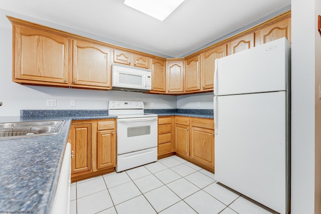 kitchen with sink, white appliances, and light tile patterned flooring