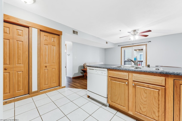 kitchen with white dishwasher, ceiling fan, light tile patterned floors, and sink