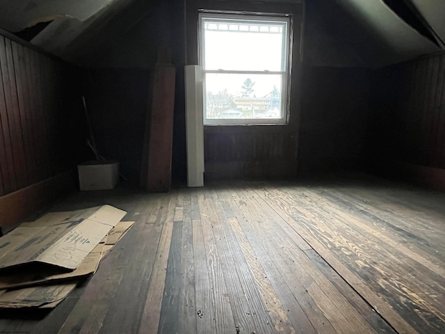 additional living space featuring wood-type flooring and vaulted ceiling