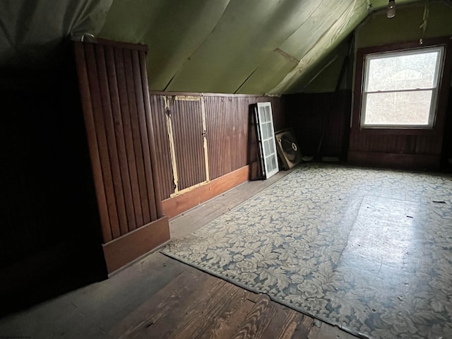 additional living space with light hardwood / wood-style floors and vaulted ceiling