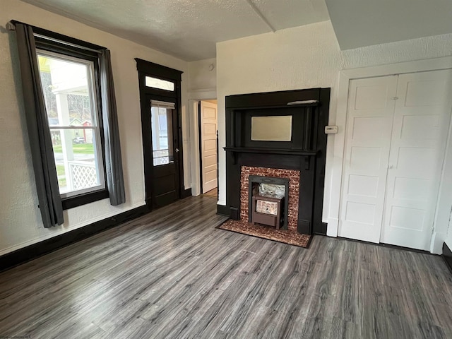 unfurnished living room featuring wood-type flooring and a textured ceiling