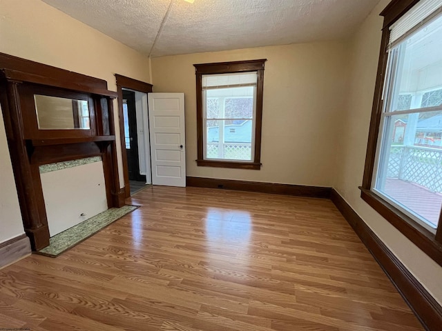 unfurnished dining area with hardwood / wood-style flooring and a textured ceiling