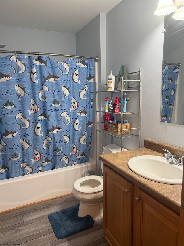 full bathroom featuring vanity, hardwood / wood-style flooring, toilet, and shower / bathtub combination with curtain