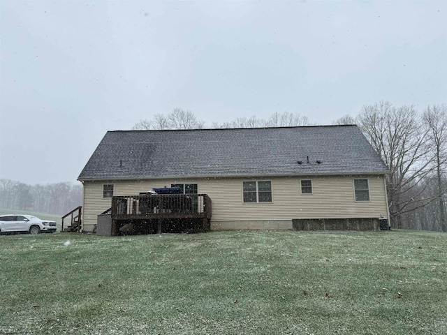 back of house with a wooden deck and a lawn