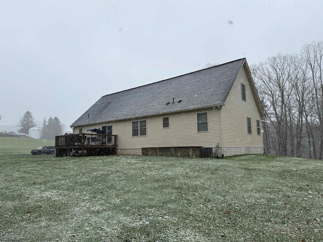 rear view of house featuring a lawn, cooling unit, and a wooden deck