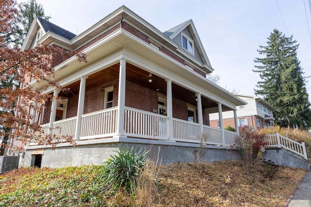 view of home's exterior with a porch and central AC