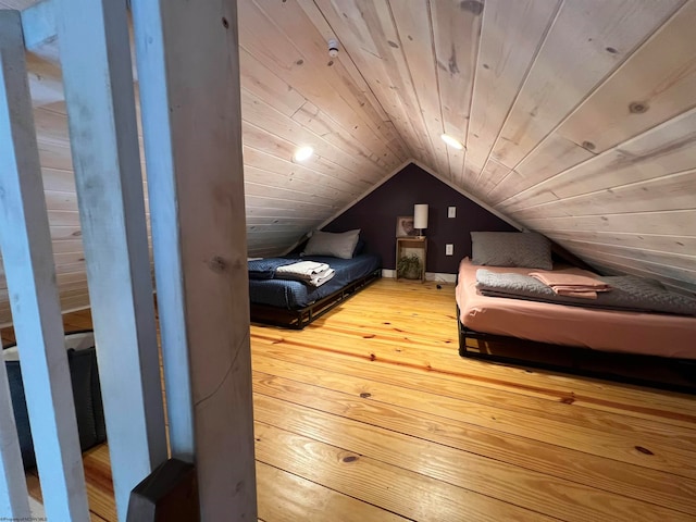 bedroom featuring light wood-type flooring, wooden ceiling, and lofted ceiling